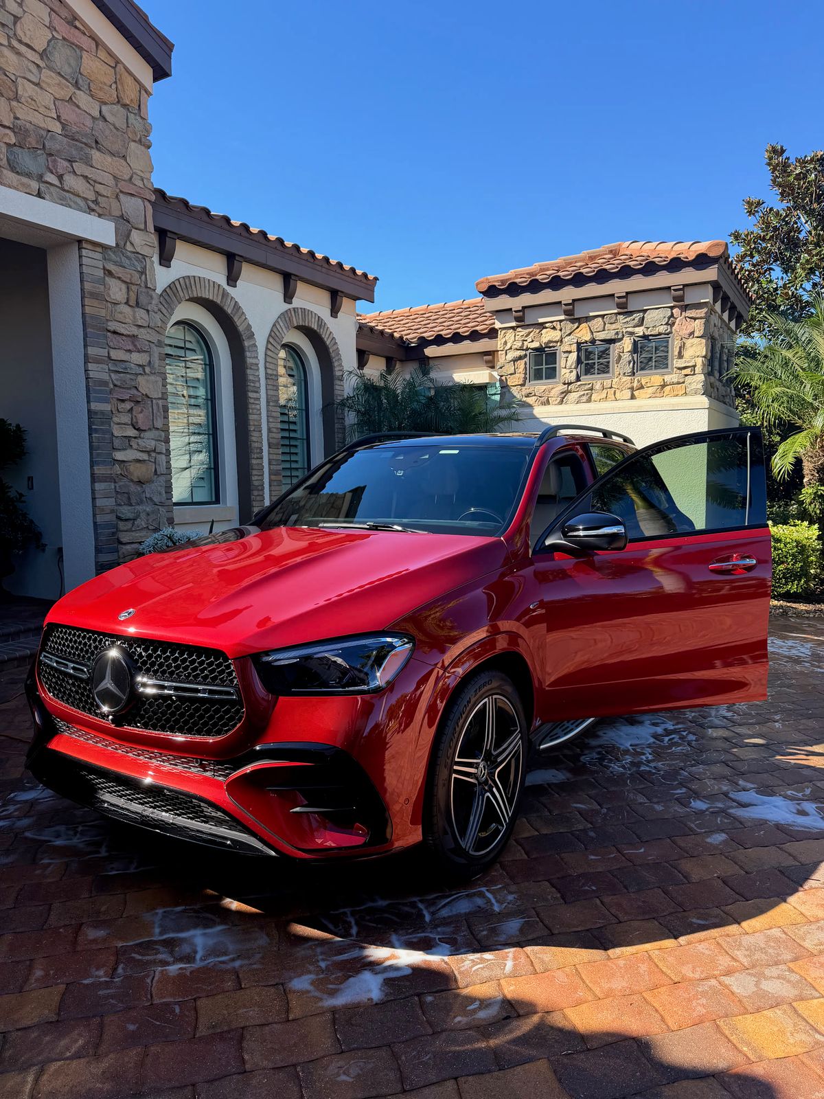 Freshly polished red SUV with a clean, reflective finish